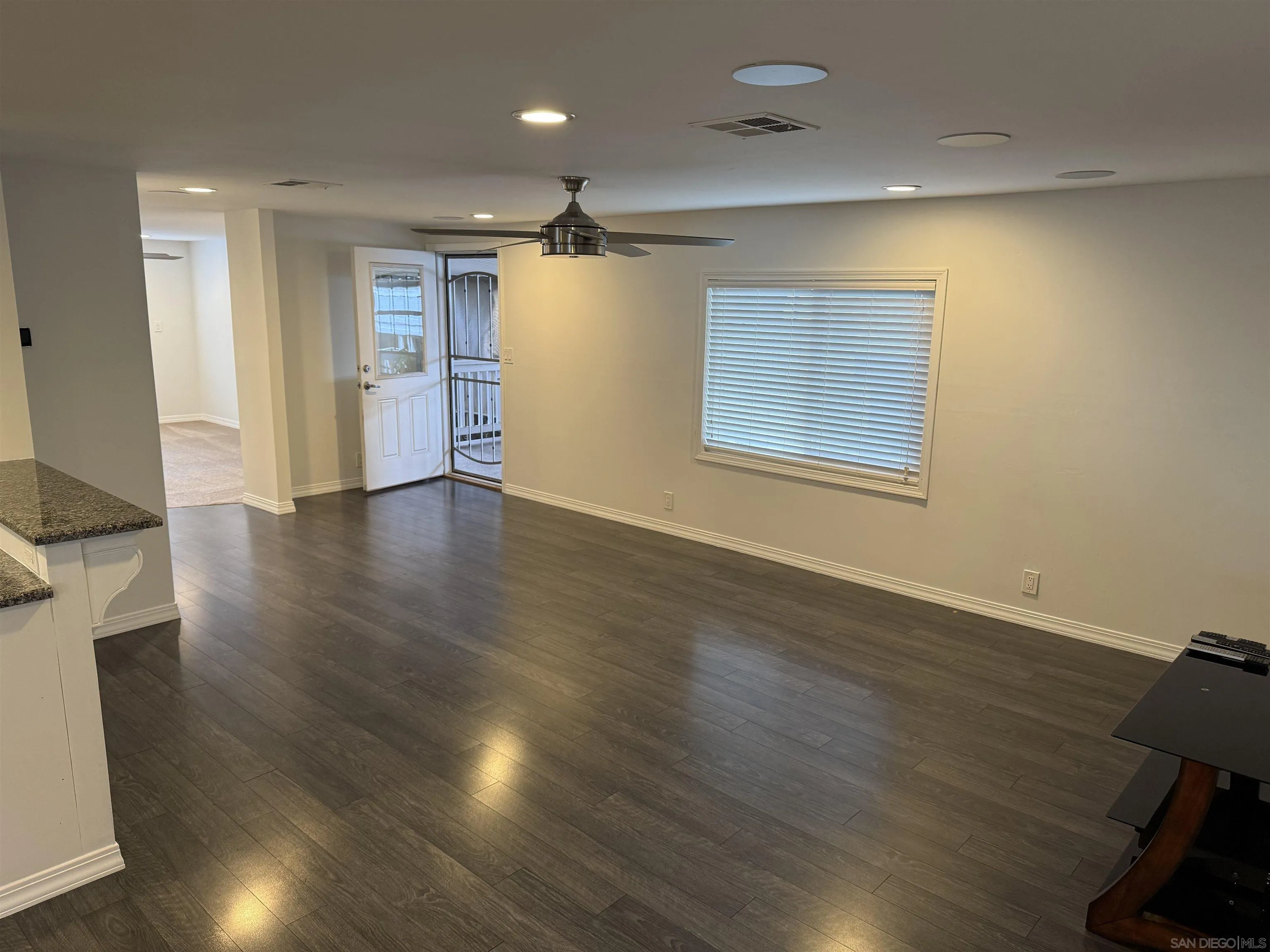 7467 Mission Gorge Road, Unit SPC 19 Santee, CA 92071 - Photo 6 of 20 a view of an empty room with wooden floor and a window