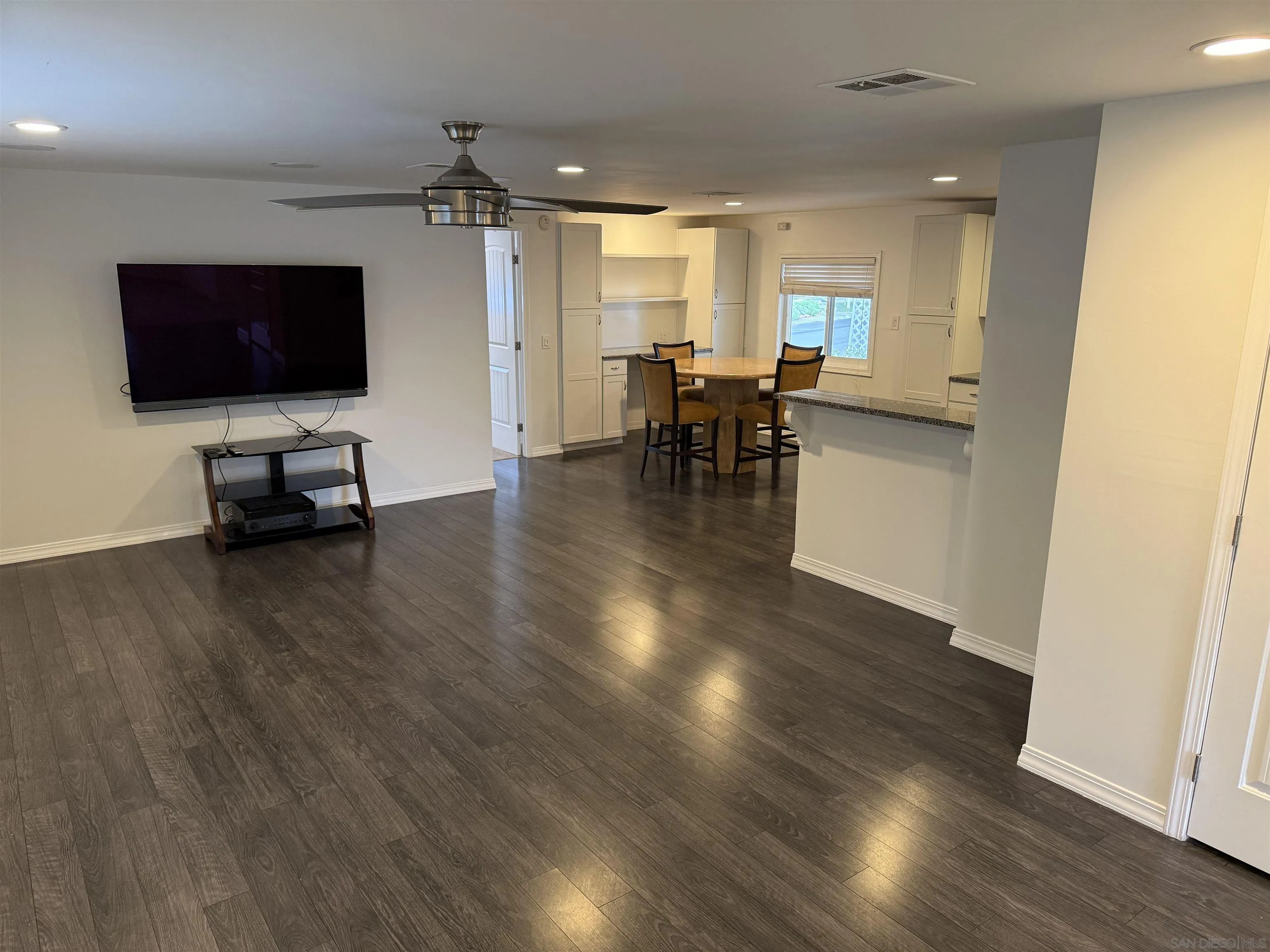 7467 Mission Gorge Road, Unit SPC 19 Santee, CA 92071 - Photo 8 of 20 a living room with furniture wooden floor and a flat screen tv
