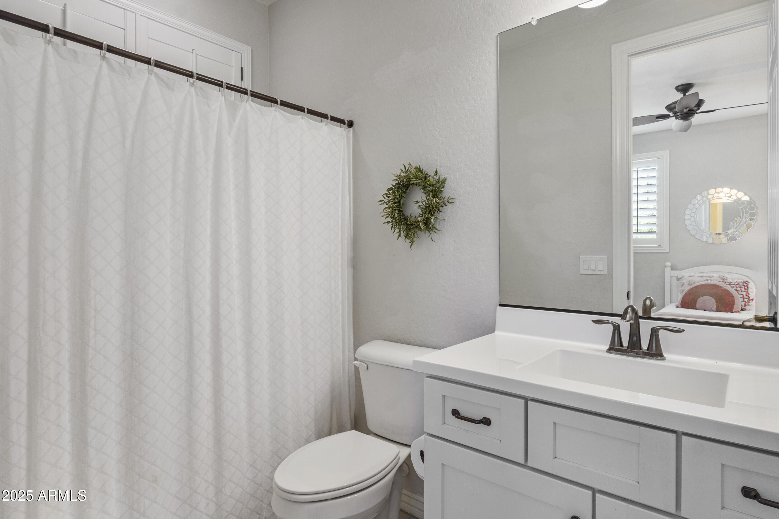 4292 East Morrison Ranch Parkway Gilbert, AZ 85296 - Photo 41 of 55 a bathroom with a sink a toilet and a mirror