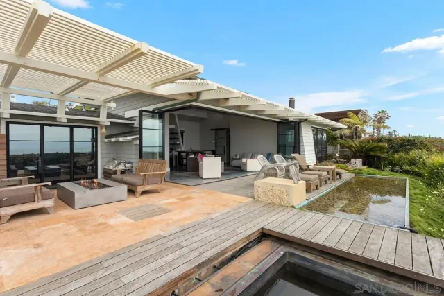 a living room with furniture dining area and a flat screen tv