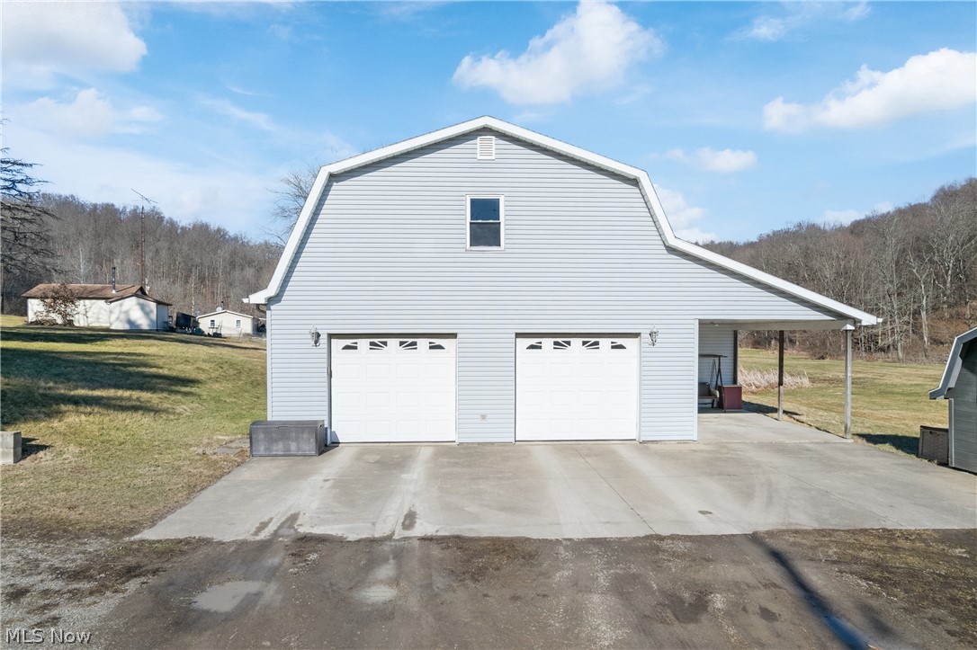 29395 Beitler Road Dennison, OH 44621 - Photo 24 of 33 View of side of home with a gambrel roof, a yard, and driveway