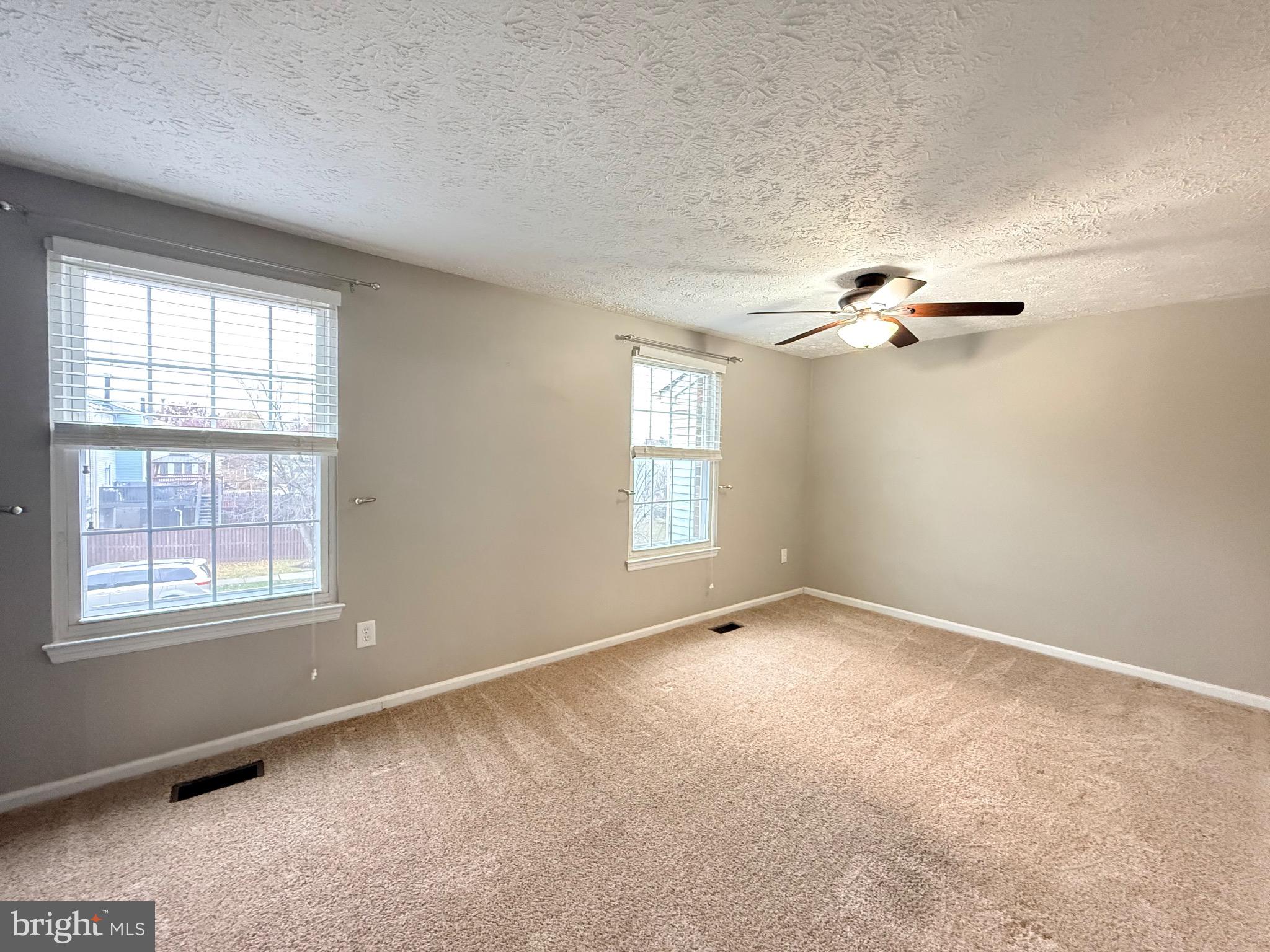 3750 Timahoe Circle Baltimore, MD 21236 - Photo 12 of 29 an empty room with windows and chandelier fan