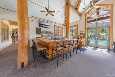 a dining hall with furniture and a floor to ceiling window