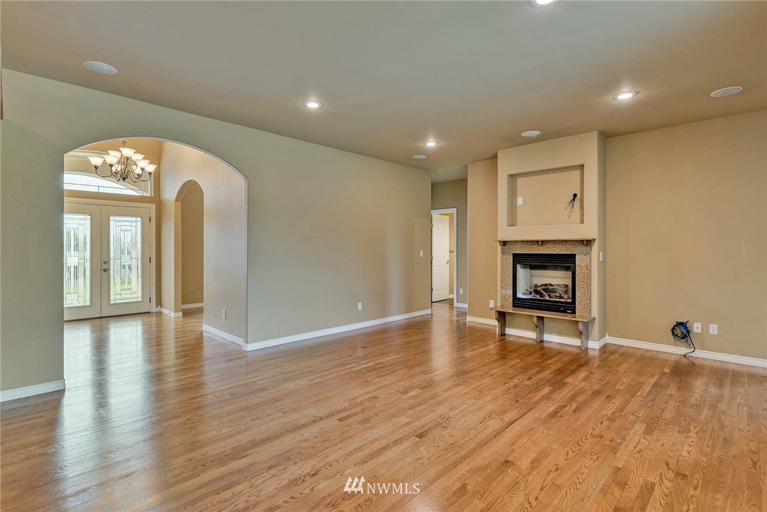 89 Springhill Drive East Wenatchee, WA 98802 - Photo 21 of 36 a view of an empty room with wooden floor and a fireplace