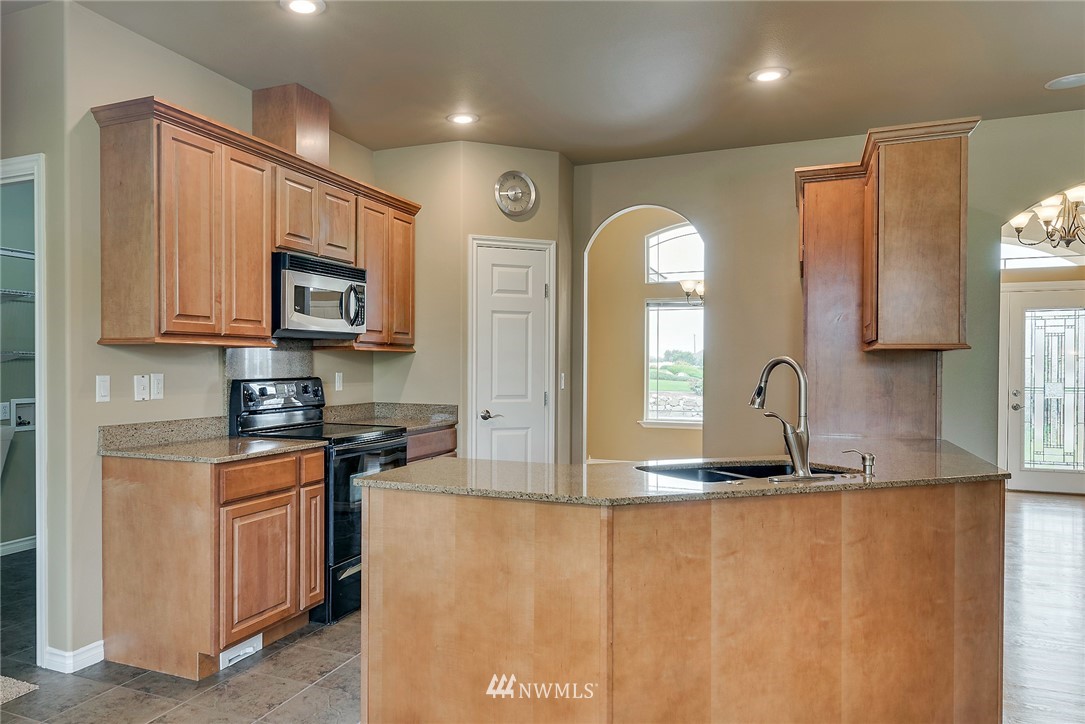 89 Springhill Drive East Wenatchee, WA 98802 - Photo 22 of 36 a kitchen with stainless steel appliances granite countertop a stove a sink and a microwave