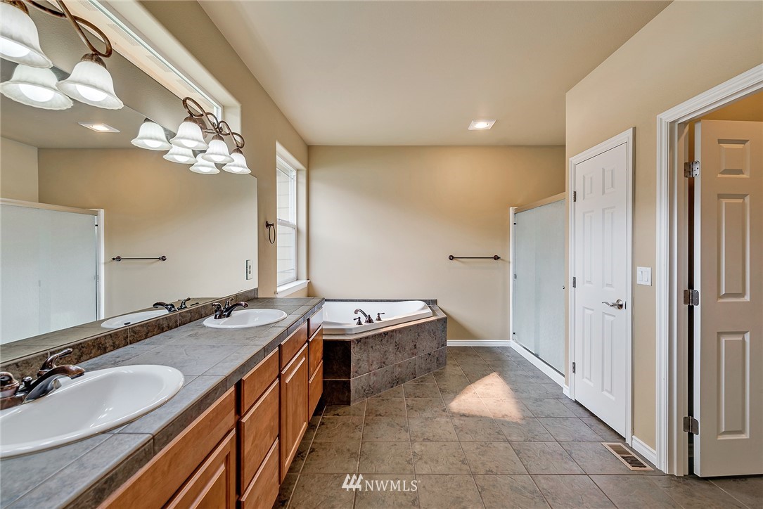89 Springhill Drive East Wenatchee, WA 98802 - Photo 27 of 36 a bathroom with a granite countertop double vanity sink and a mirror