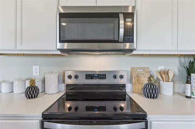 a kitchen with a stove and a microwave