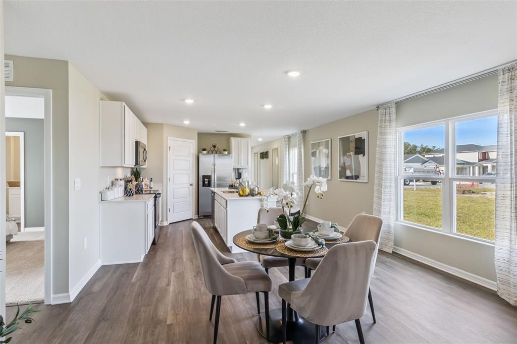3433 Nettle Loop Tavares, FL 32778 - Photo 12 of 31 a view of a dining room with furniture and wooden floor