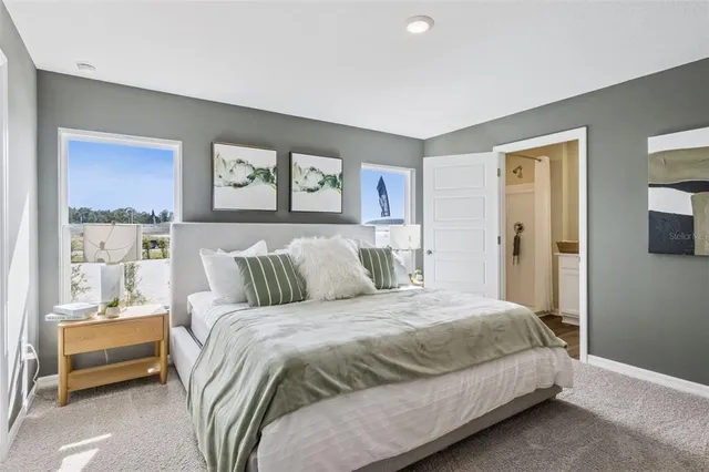 a bedroom with a bed and a night stand