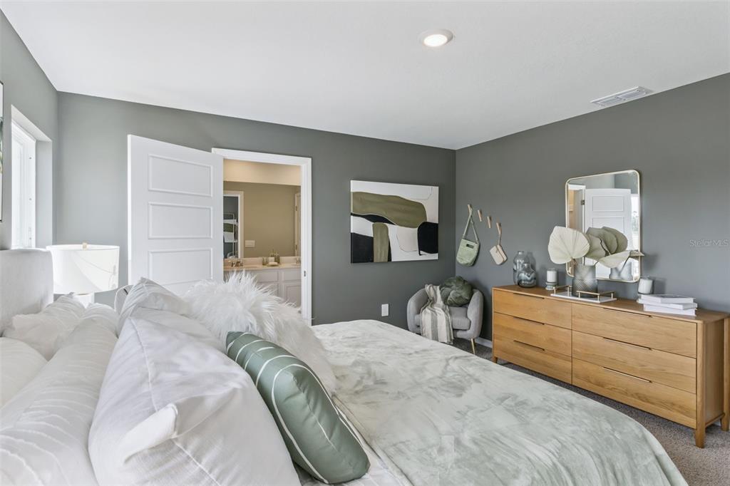 3433 Nettle Loop Tavares, FL 32778 - Photo 20 of 31 a bedroom with a bed and wooden floor