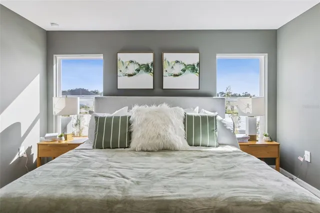 a bed sitting in a bedroom next to a window