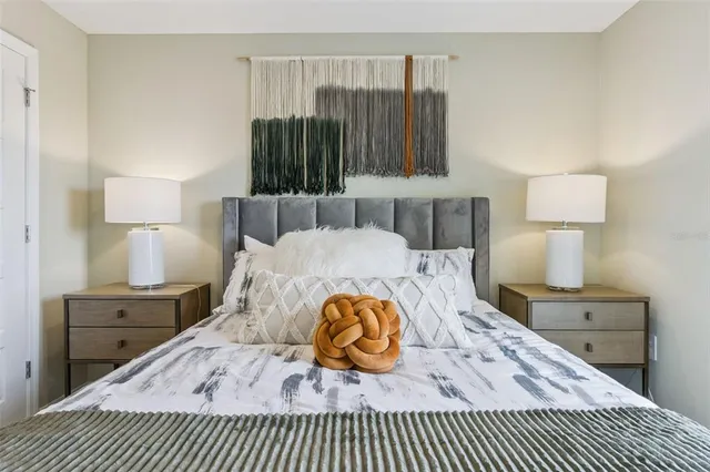 a bedroom with a bed and a night stand