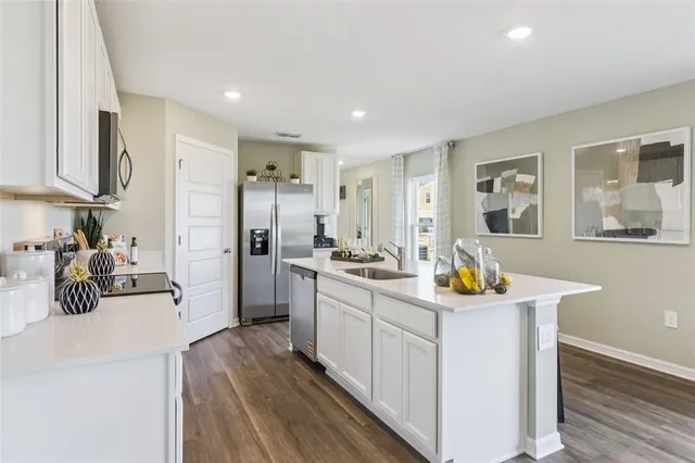 a kitchen with sink cabinets and refrigerator