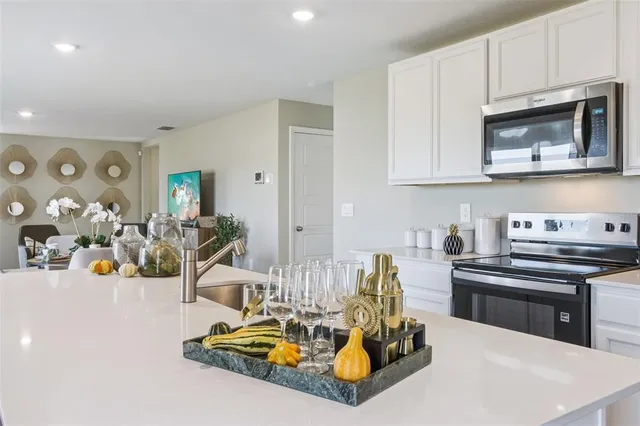 a kitchen with stainless steel appliances kitchen island granite countertop a sink and cabinets