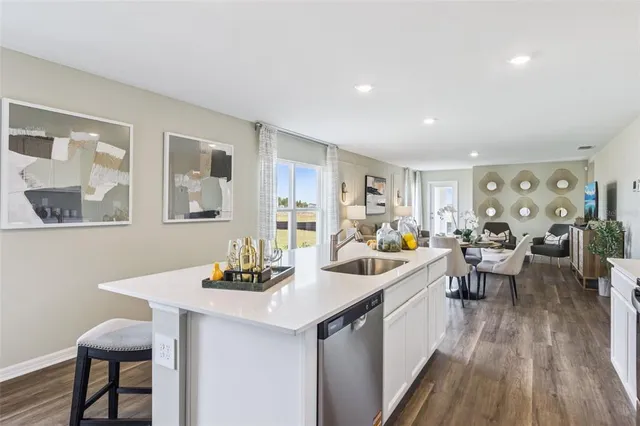 a kitchen that has a table and chairs in it
