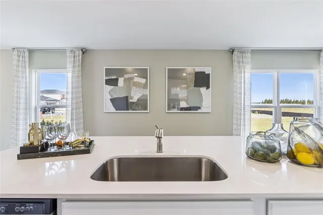 a kitchen with sink and cabinets