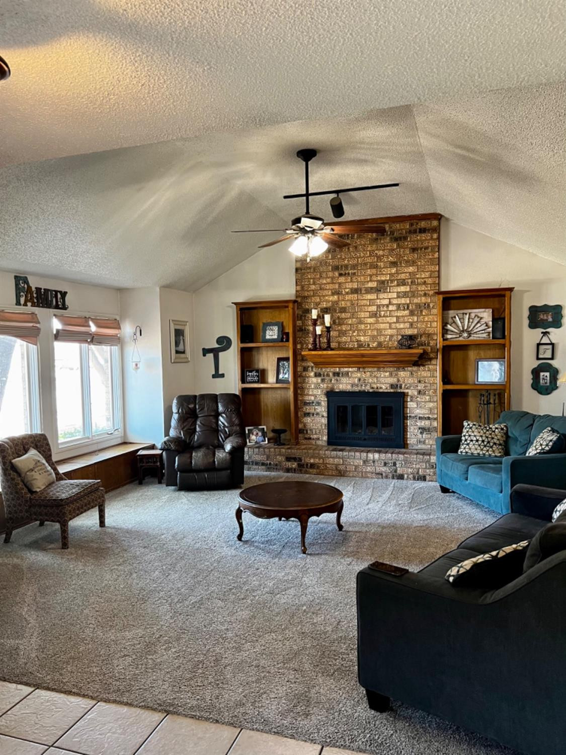 5724 92nd Street Lubbock, TX 79424 - Photo 1 of 18 a living room with furniture and a fireplace