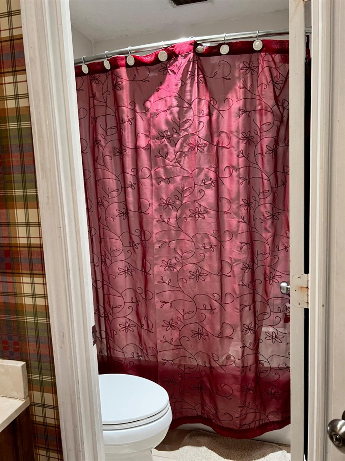 5724 92nd Street Lubbock, TX 79424 - Photo 12 of 18 a bathroom with a toilet and a shower curtain