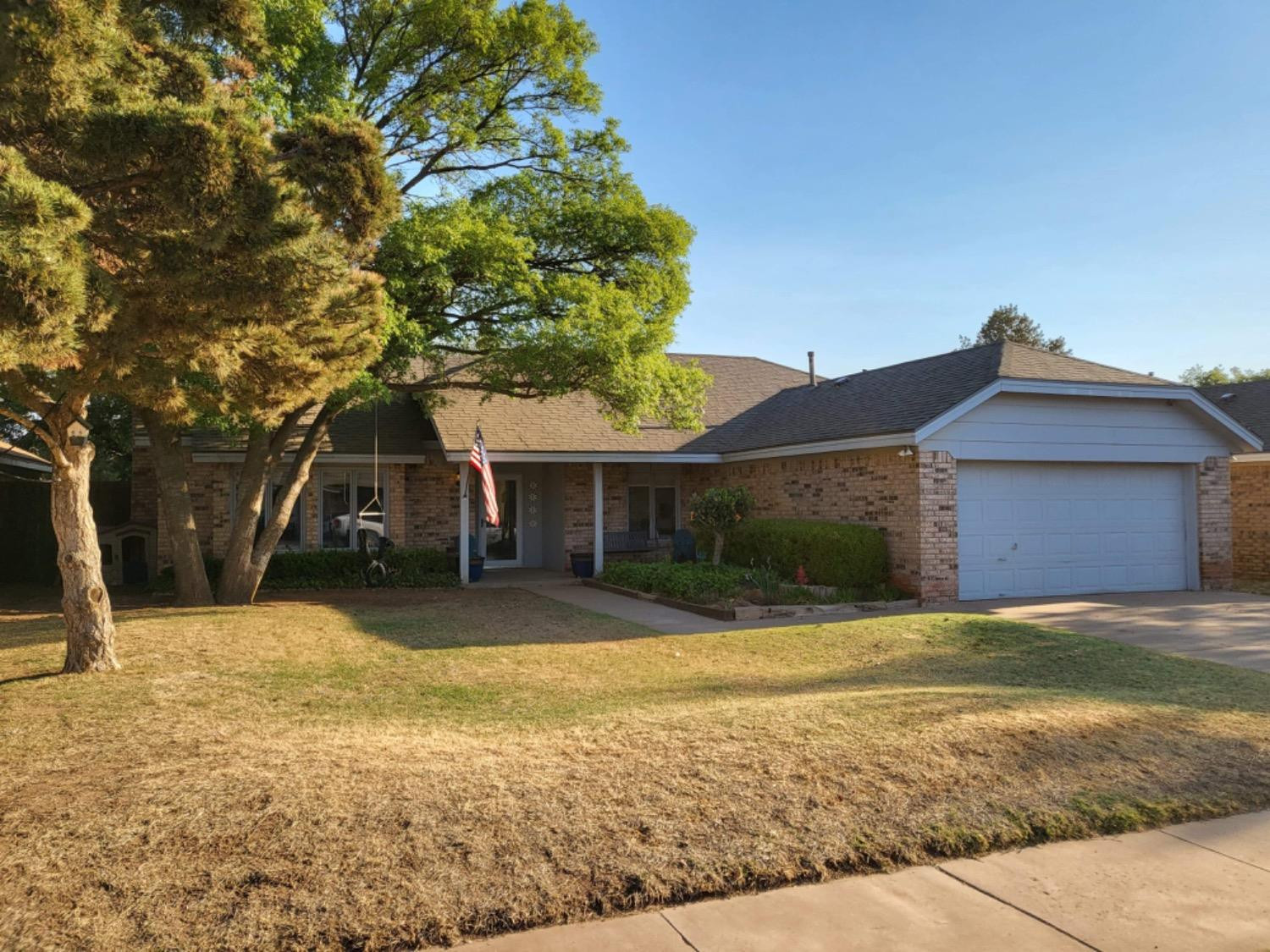 5724 92nd Street Lubbock, TX 79424 - Photo 16 of 18 a front view of a house with a yard