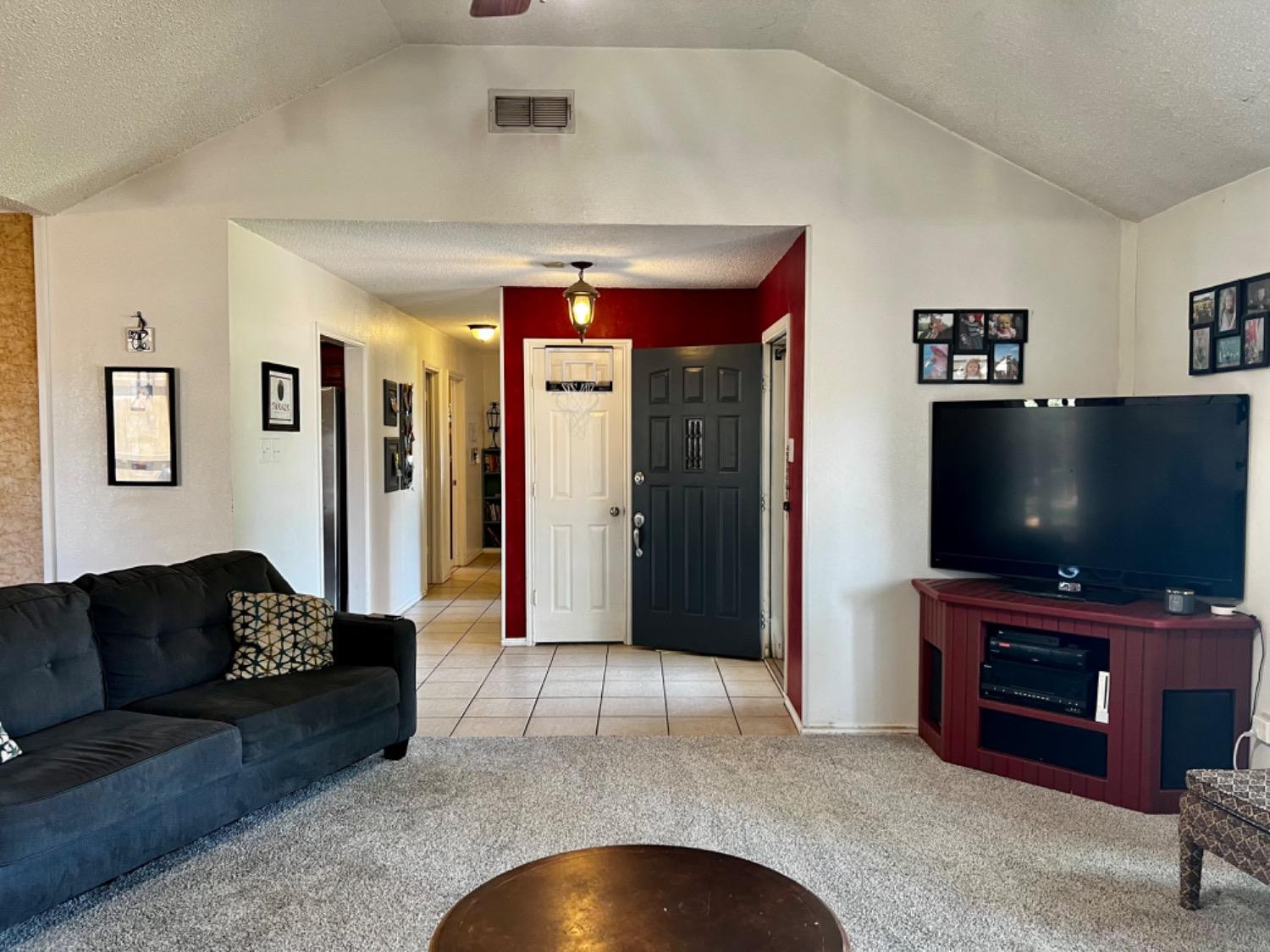5724 92nd Street Lubbock, TX 79424 - Photo 17 of 18 a living room with furniture and a flat screen tv
