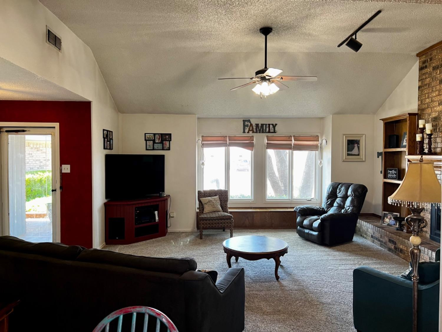 5724 92nd Street Lubbock, TX 79424 - Photo 3 of 18 a living room with furniture and a flat screen tv