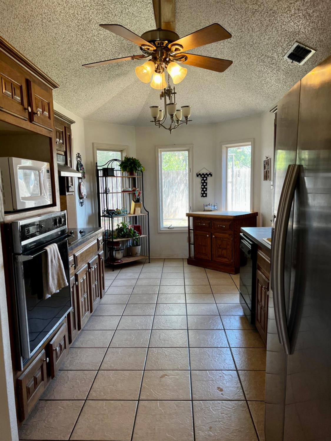 5724 92nd Street Lubbock, TX 79424 - Photo 5 of 18 a kitchen with stainless steel appliances granite countertop a refrigerator and a sink