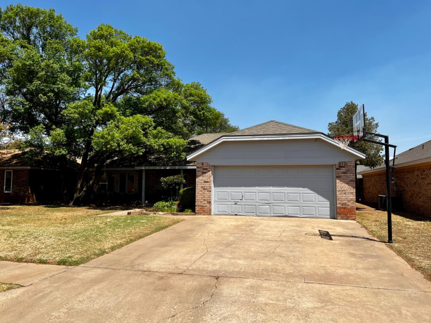 5724 92nd Street Lubbock, TX 79424 - Photo 7 of 18 a view of a house with a yard