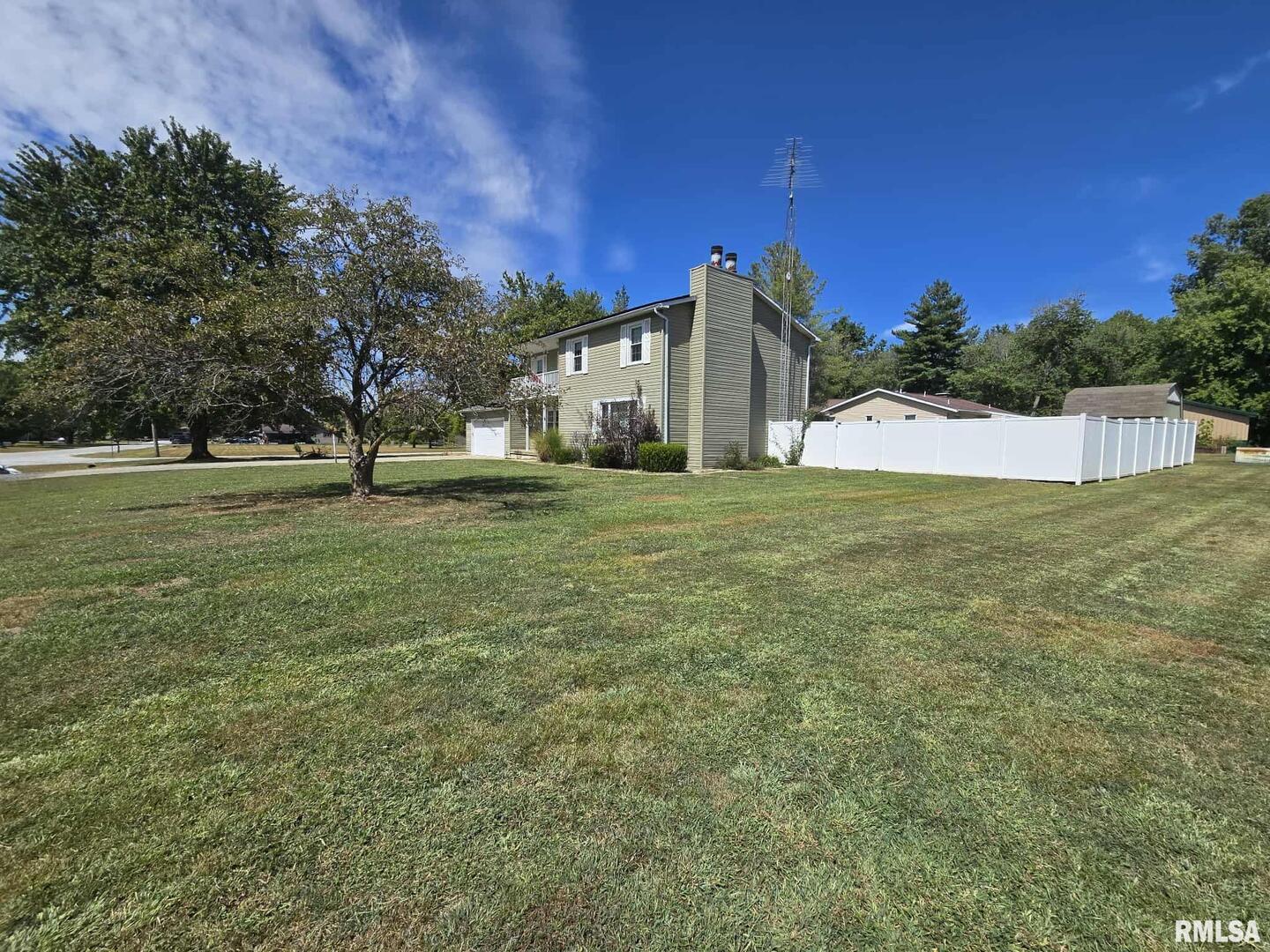 108 Mockingbird Lane Woodlawn, IL 62898 - Photo 14 of 59 a view of a big house with a big yard and a large trees