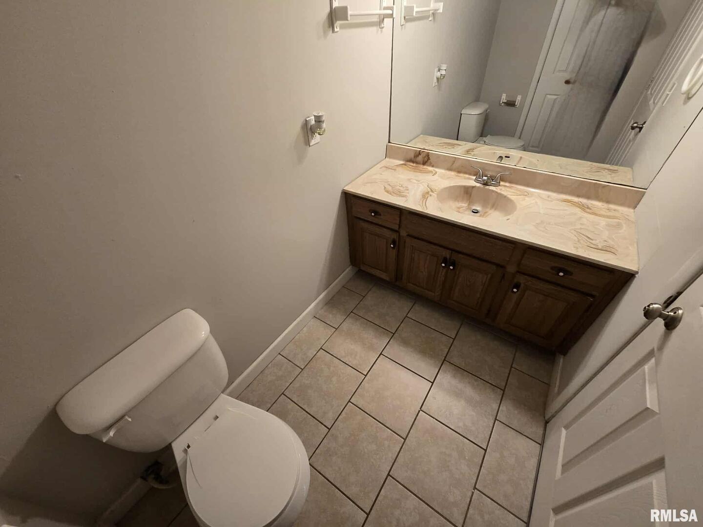 108 Mockingbird Lane Woodlawn, IL 62898 - Photo 31 of 59 a bathroom with a toilet sink and mirror