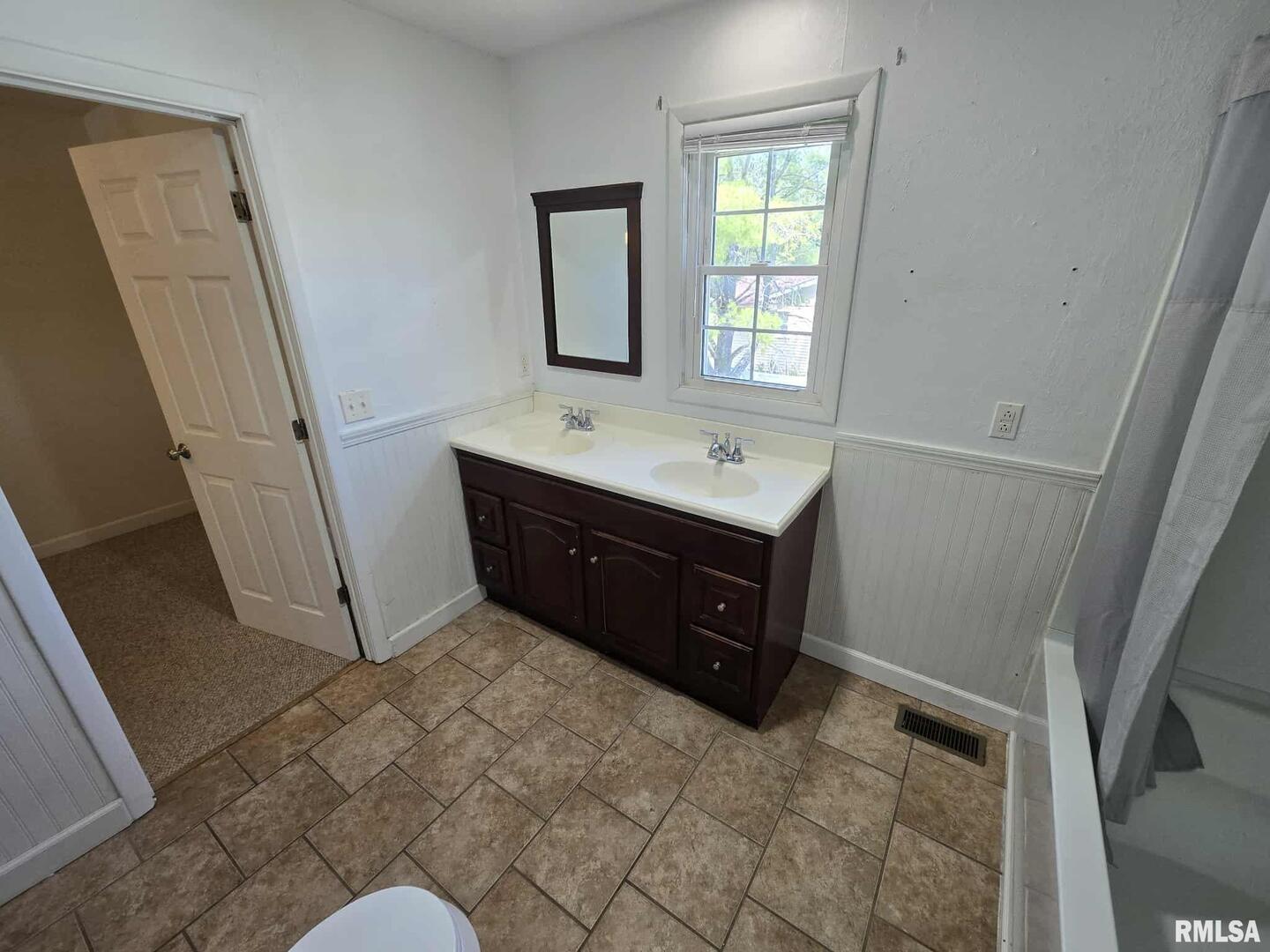 108 Mockingbird Lane Woodlawn, IL 62898 - Photo 46 of 59 a room with a sink a mirror and a toilet