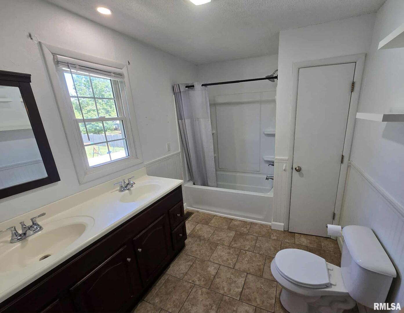108 Mockingbird Lane Woodlawn, IL 62898 - Photo 47 of 59 a bathroom with a double vanity sink toilet mirror and bathtub
