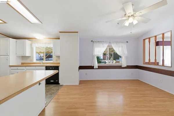 a kitchen with a stove a sink and a window