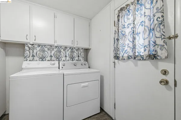 a view of storage and utility room with washer and dryer