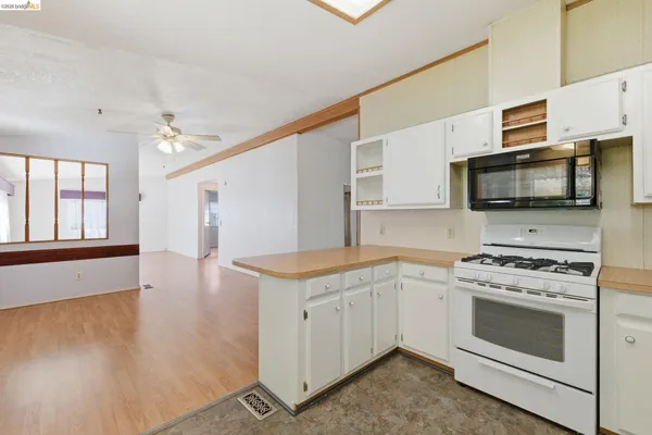 a kitchen with a stove a sink and a microwave