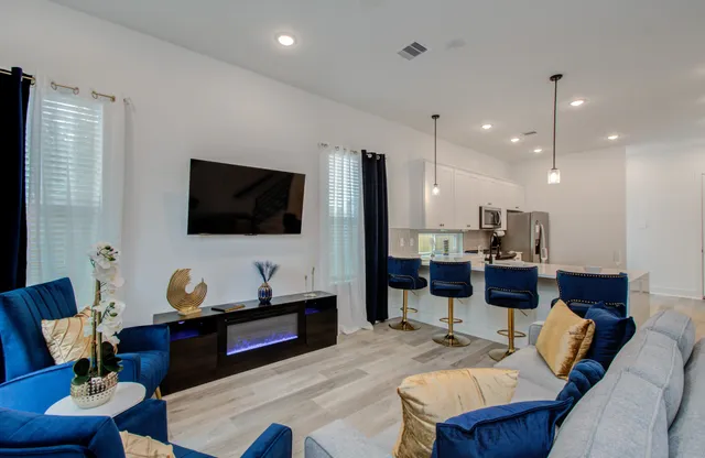 a living room with furniture and a flat screen tv