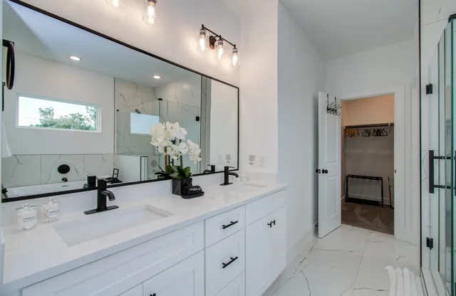 a view of hall way with mirror and furniture