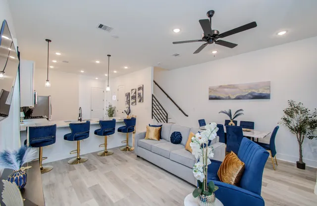 a living room with furniture and a chandelier