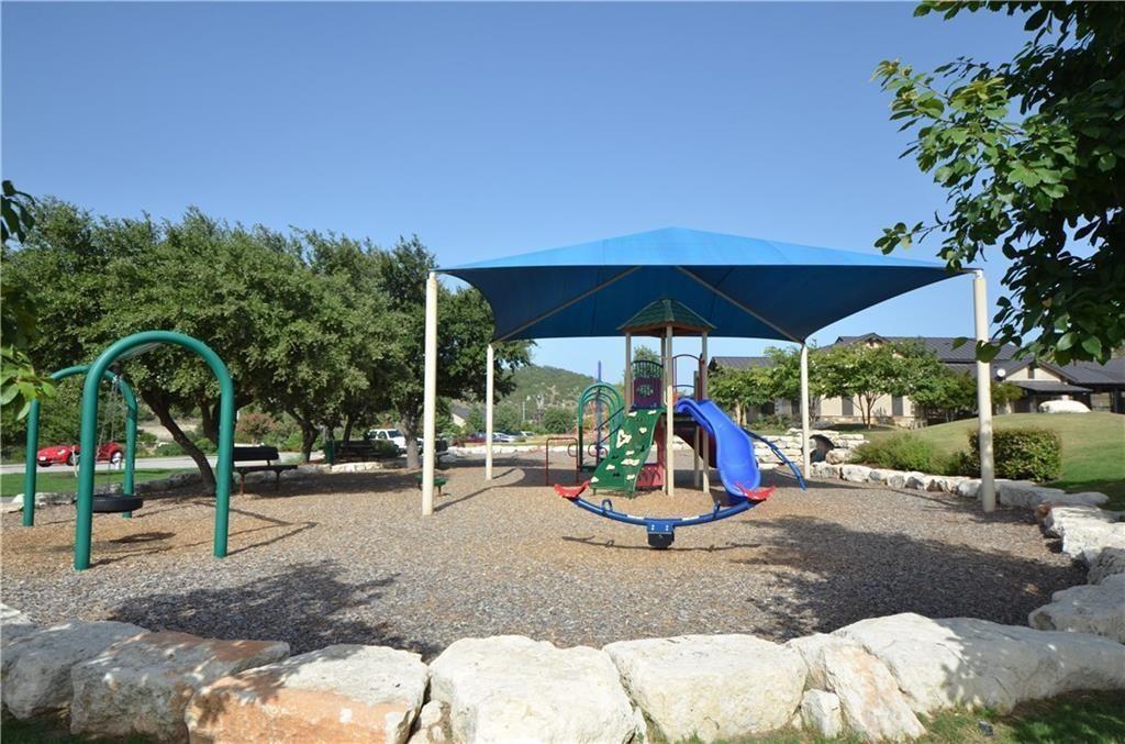 5629 Rio Chama Cove Austin, TX 78738 - Photo 33 of 34 A well-maintained playground provides recreation for residents, complete with shaded play structures.
