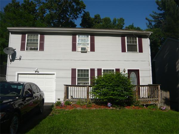 a view of a house with a backyard