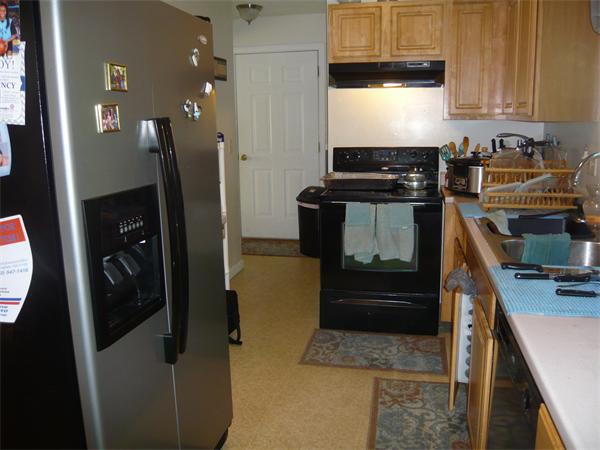 23 Ambrose Street Springfield, MA 01109 - Photo 6 of 15 a kitchen with a refrigerator and a stove top oven