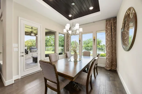 a view of a dining room with furniture wooden floor and chandelier