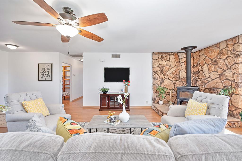 3303 Cherry Acres Road Cool, CA 95614 - Photo 2 of 83 Spacious living area featuring a wood stove, wood finished floors, and a ceiling fan
