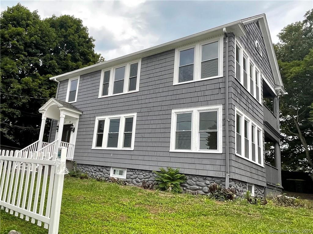 21 Lake Street Waterbury, CT 06708 - Photo 1 of 1 a brick house with a small yard front of it