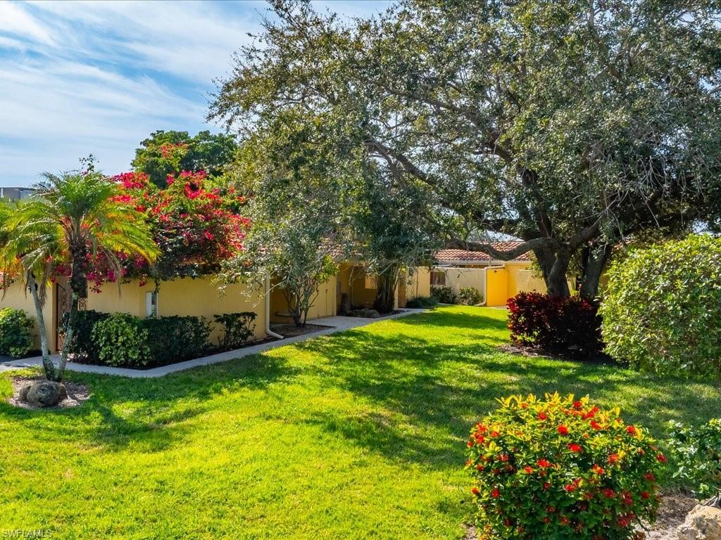 186 Harrison Road, Unit H2 Naples, FL 34112 - Photo 12 of 38 Rear view of property with stucco siding