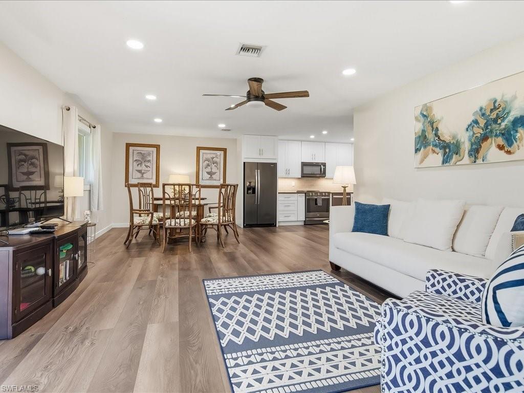 186 Harrison Road, Unit H2 Naples, FL 34112 - Photo 16 of 38 a living room with furniture and kitchen view