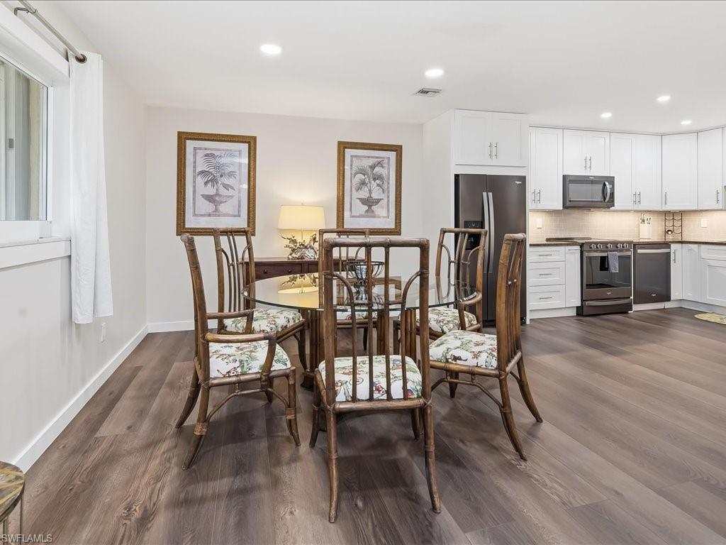 186 Harrison Road, Unit H2 Naples, FL 34112 - Photo 17 of 38 a view of a dining room with furniture and wooden floor
