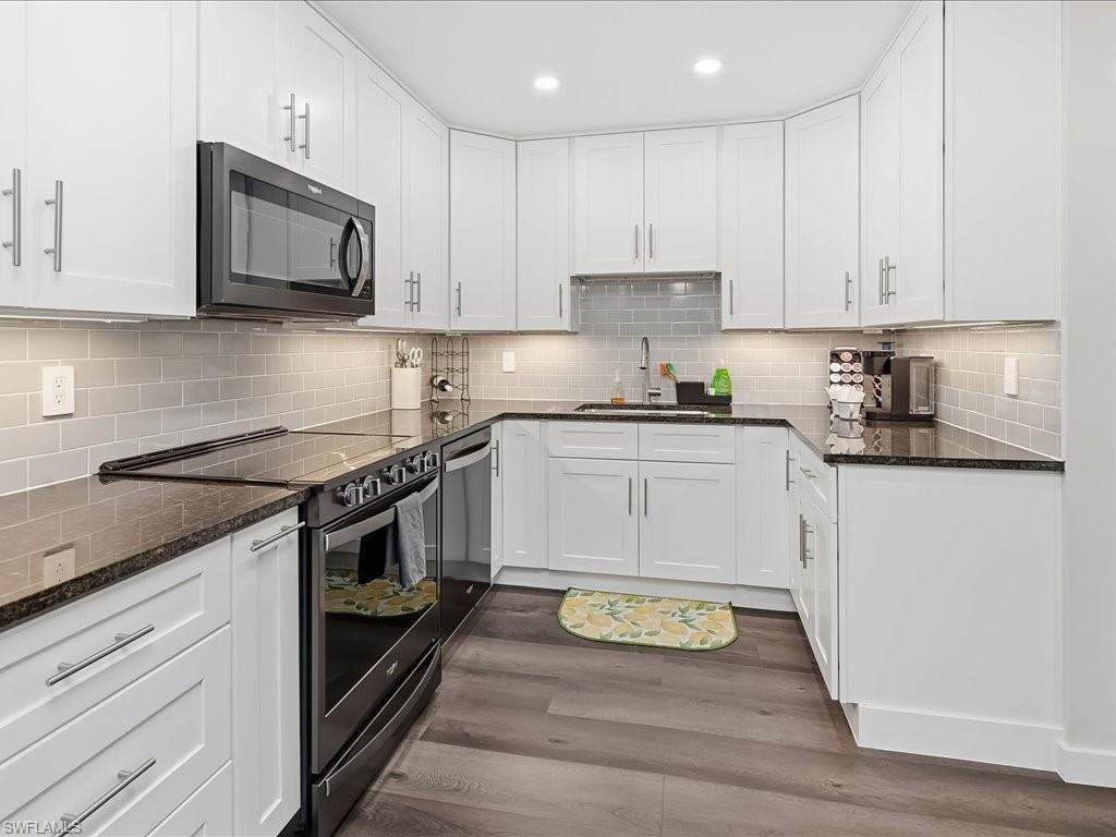 186 Harrison Road, Unit H2 Naples, FL 34112 - Photo 20 of 38 a kitchen with stainless steel appliances granite countertop a stove a sink and a microwave
