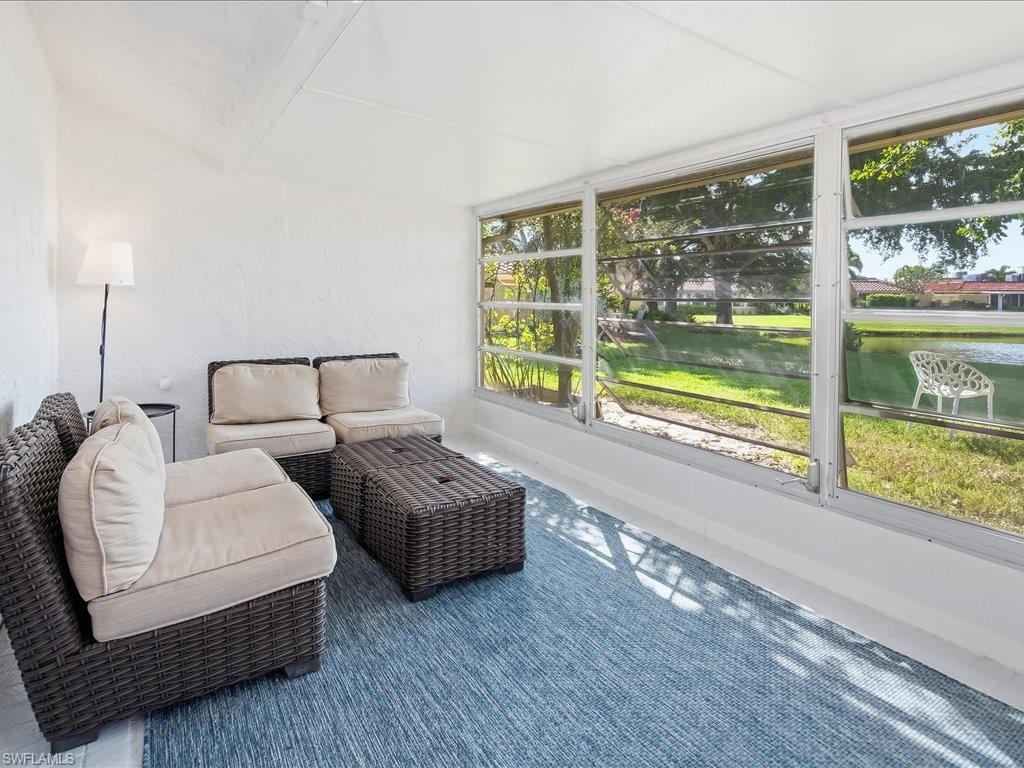 186 Harrison Road, Unit H2 Naples, FL 34112 - Photo 21 of 38 a bedroom with bed and a large window