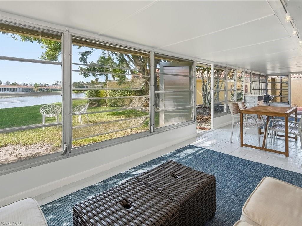 186 Harrison Road, Unit H2 Naples, FL 34112 - Photo 22 of 38 Sunroom / solarium with a water view, healthy amount of natural light, and outdoor dining space