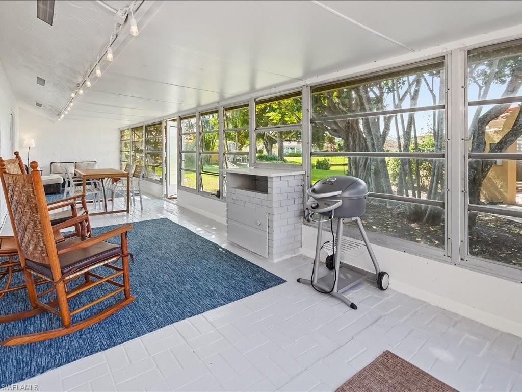 186 Harrison Road, Unit H2 Naples, FL 34112 - Photo 25 of 38 Sunroom with baseboards and track lighting